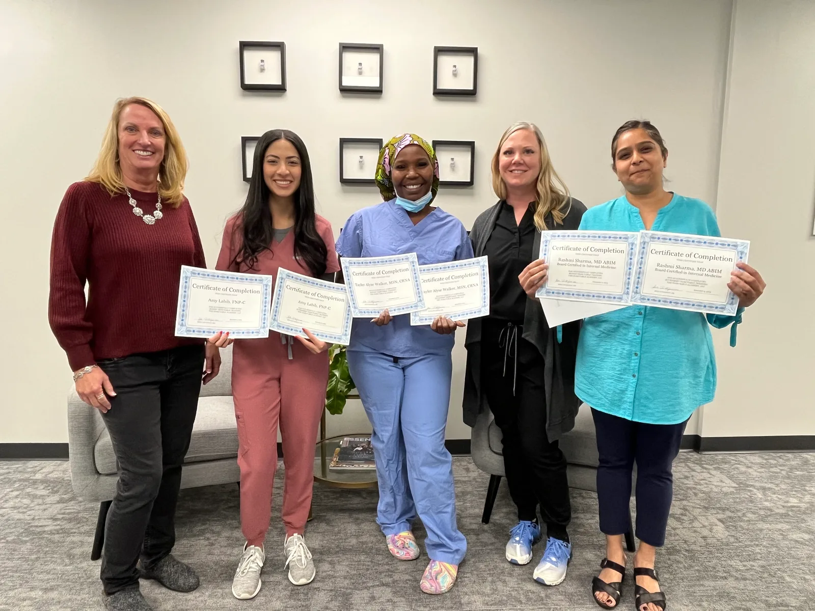 Atlanta class participants hold their certificates beside an Academy instructor