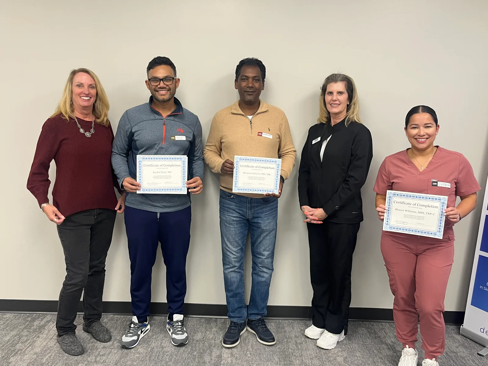 Three Atlanta graduates hold certificates with two Academy instructors