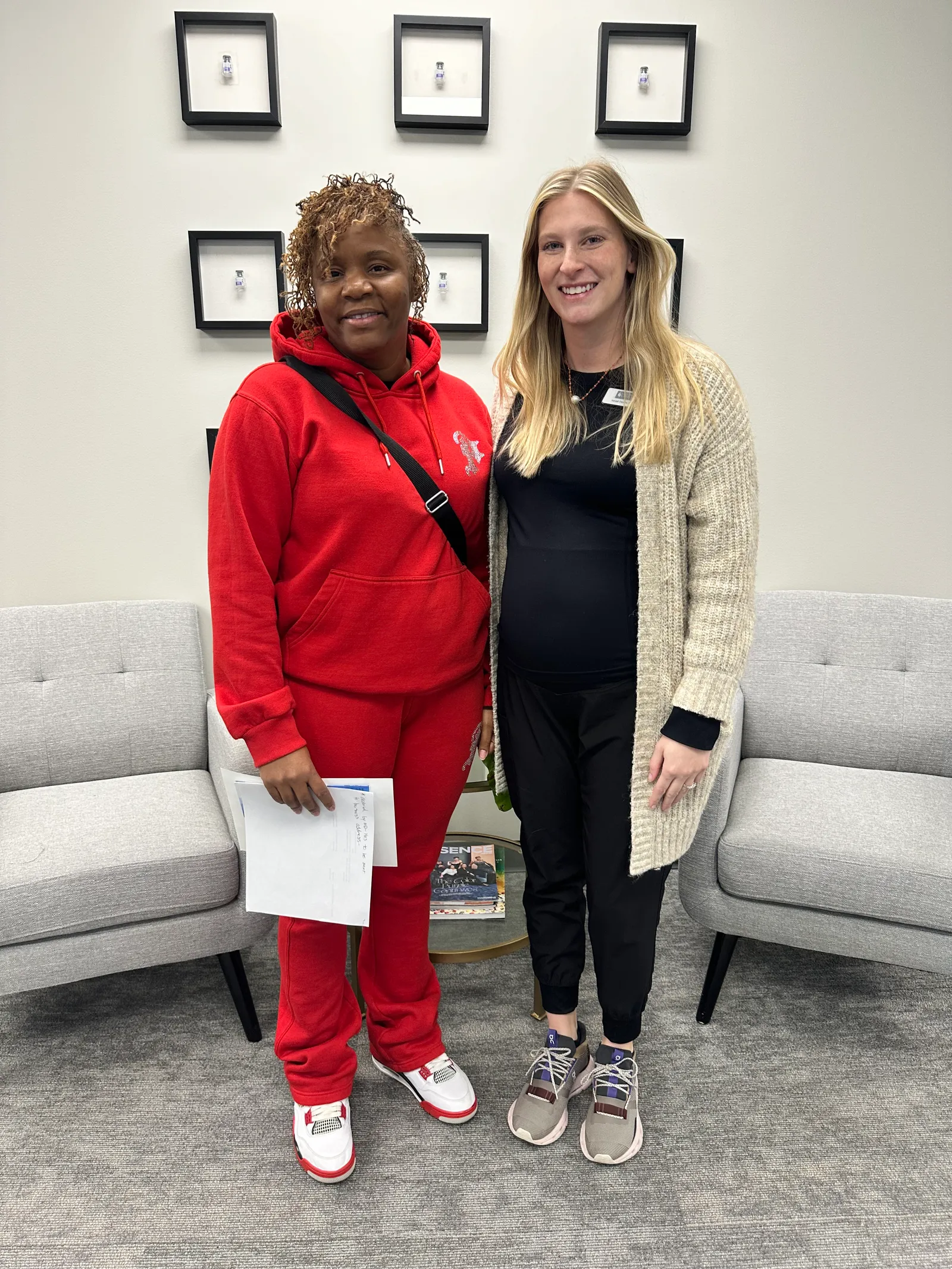 A NEXT STEP participant in red stands beside an Academy instructor in Atlanta