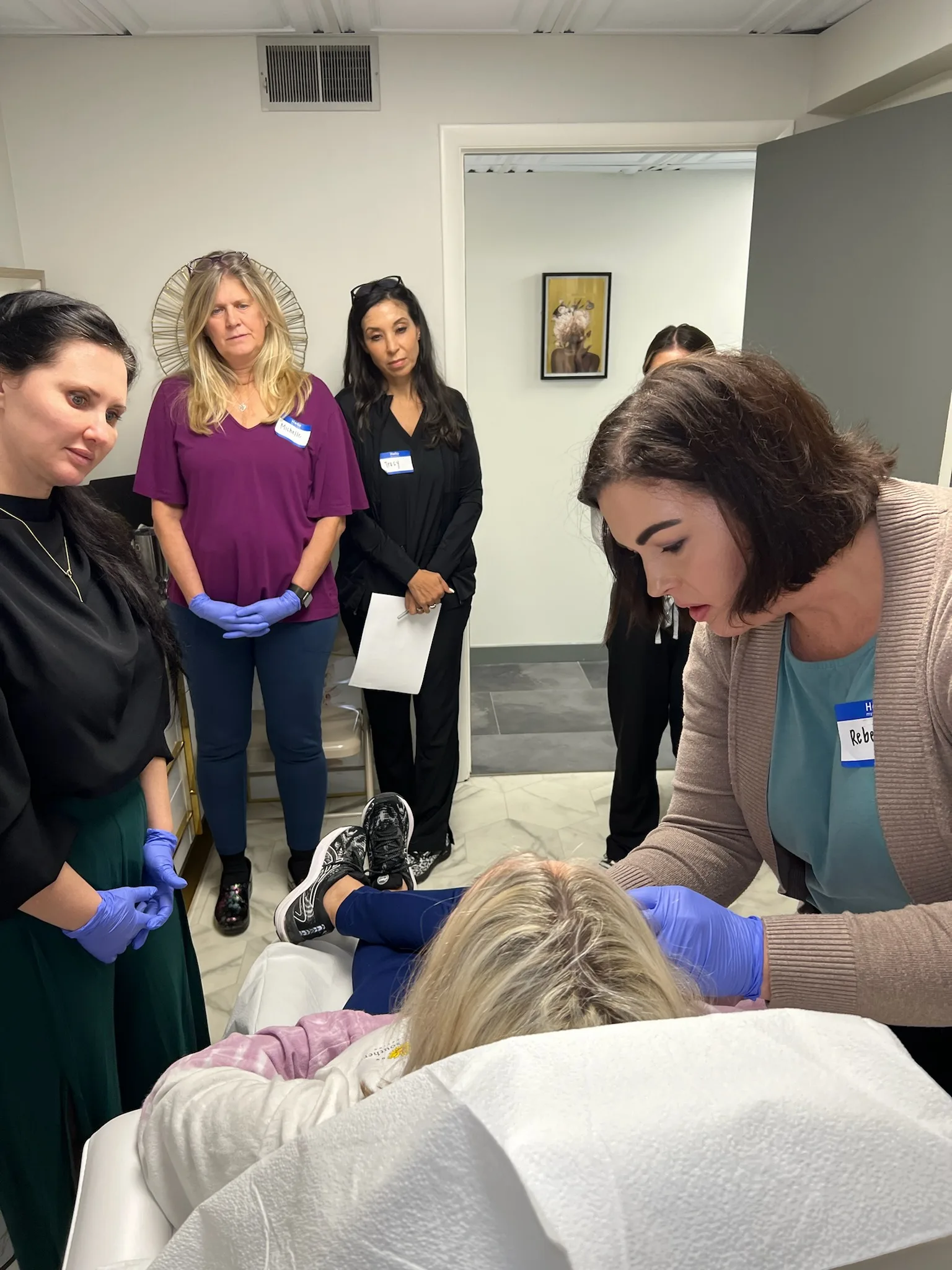 Class participants watch an instructor demonstrate on a live model in Savannah